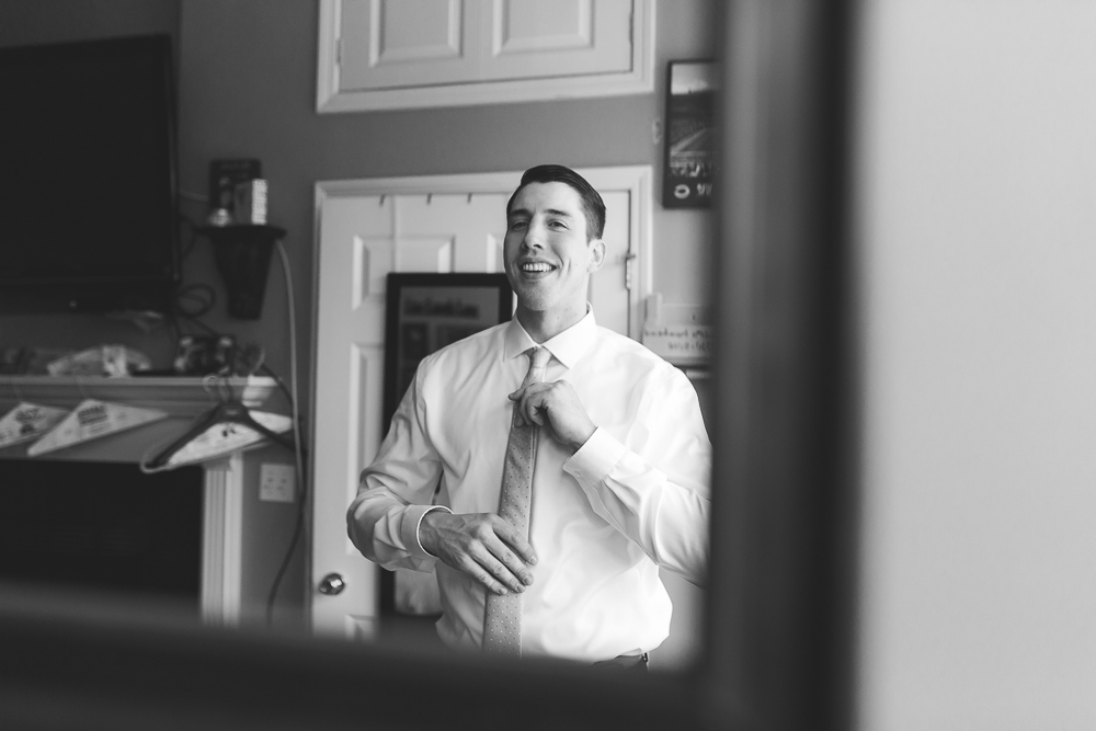 groom smiling in reflection summer wedding florals natural sage | hawaii elopement photography | elle rose photo hawaii wedding photographer