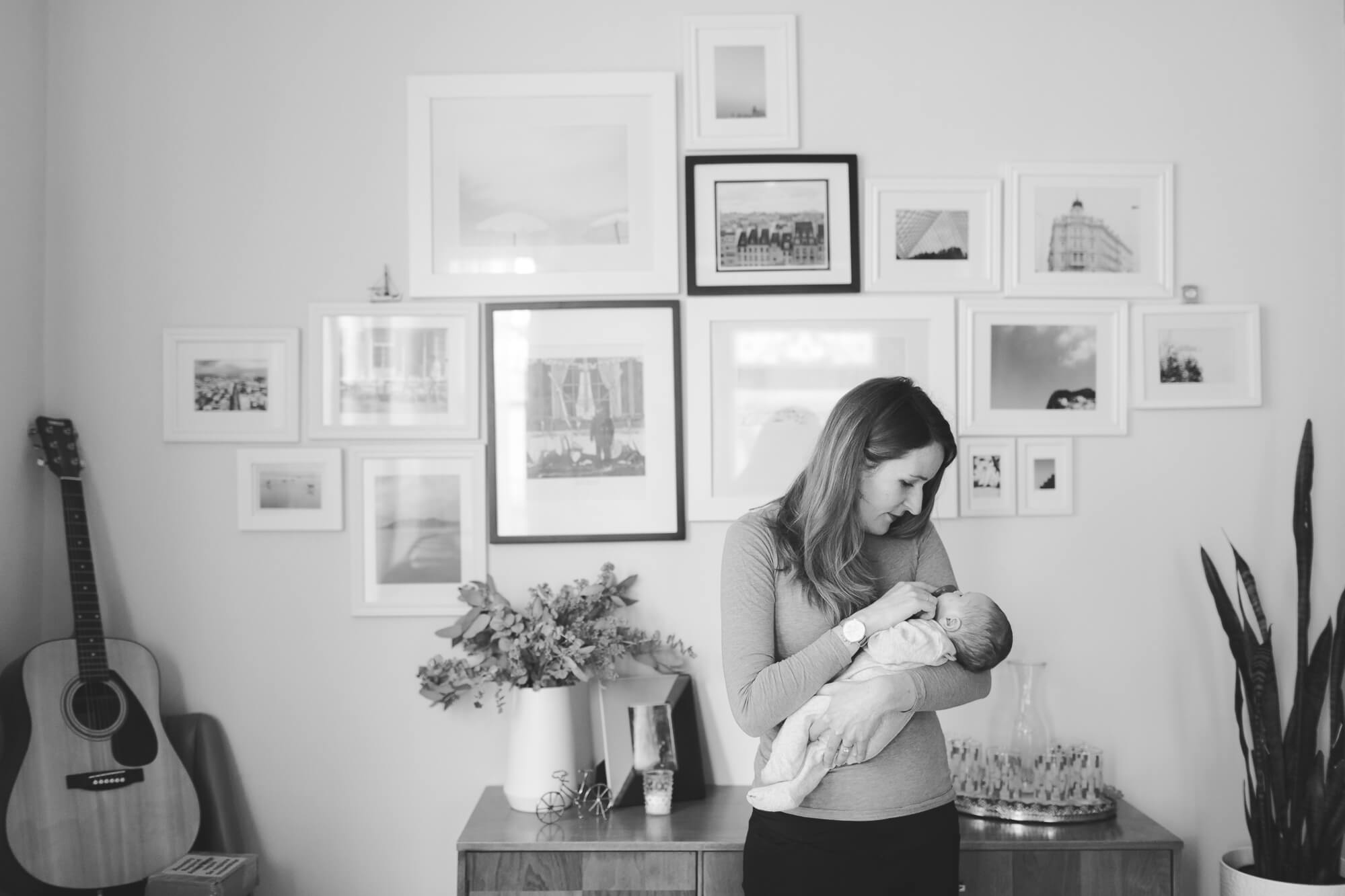 gallery wall mom holding new baby | hawaii family oahu newborn kailua photography elle rose photo in home lifestyle session with baby in stylish house