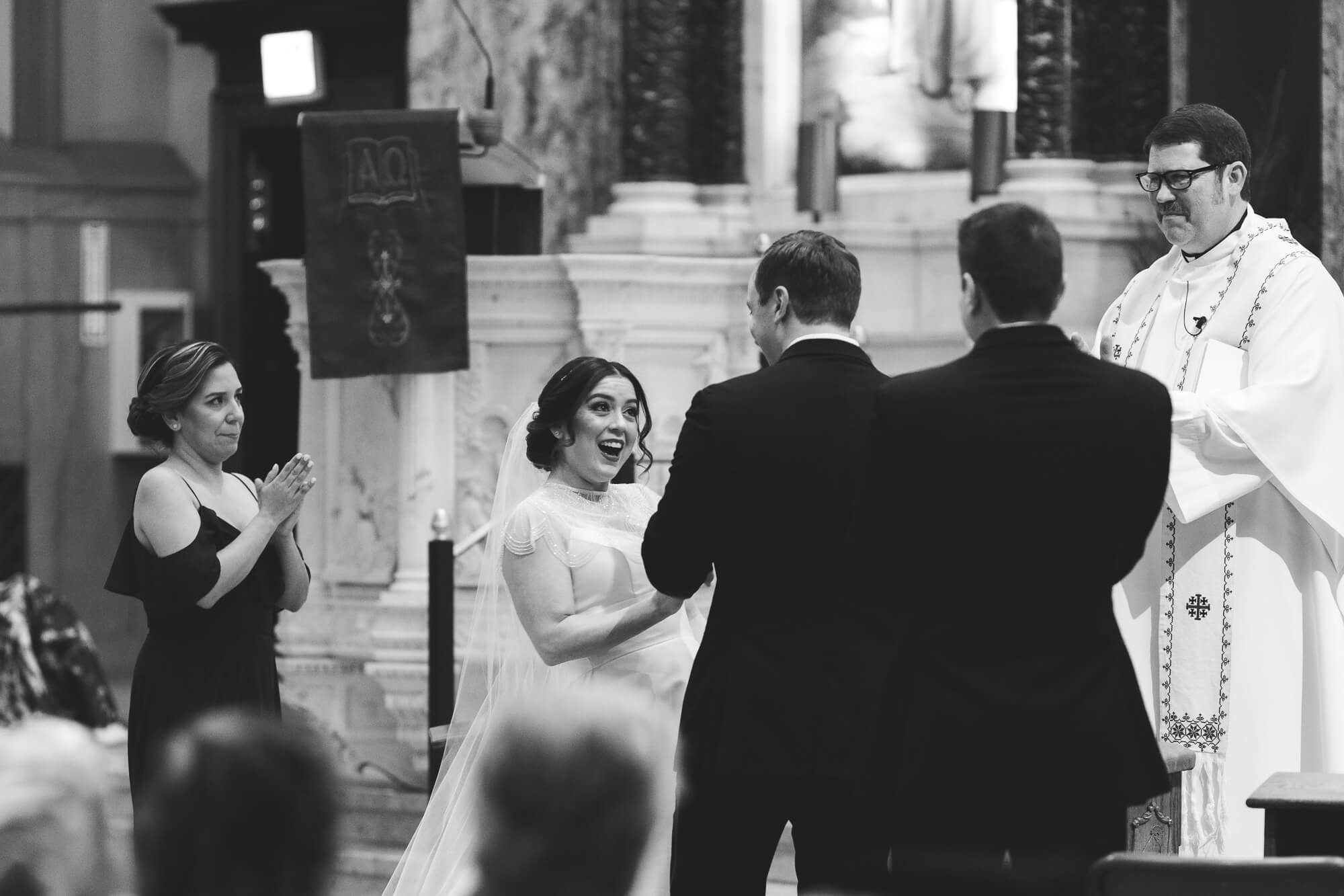 happy bride looking at groom during ceremony | hawaii black tie wedding oahu family photography elle rose photo | glamorous destination winter wedding at thompson chicago 