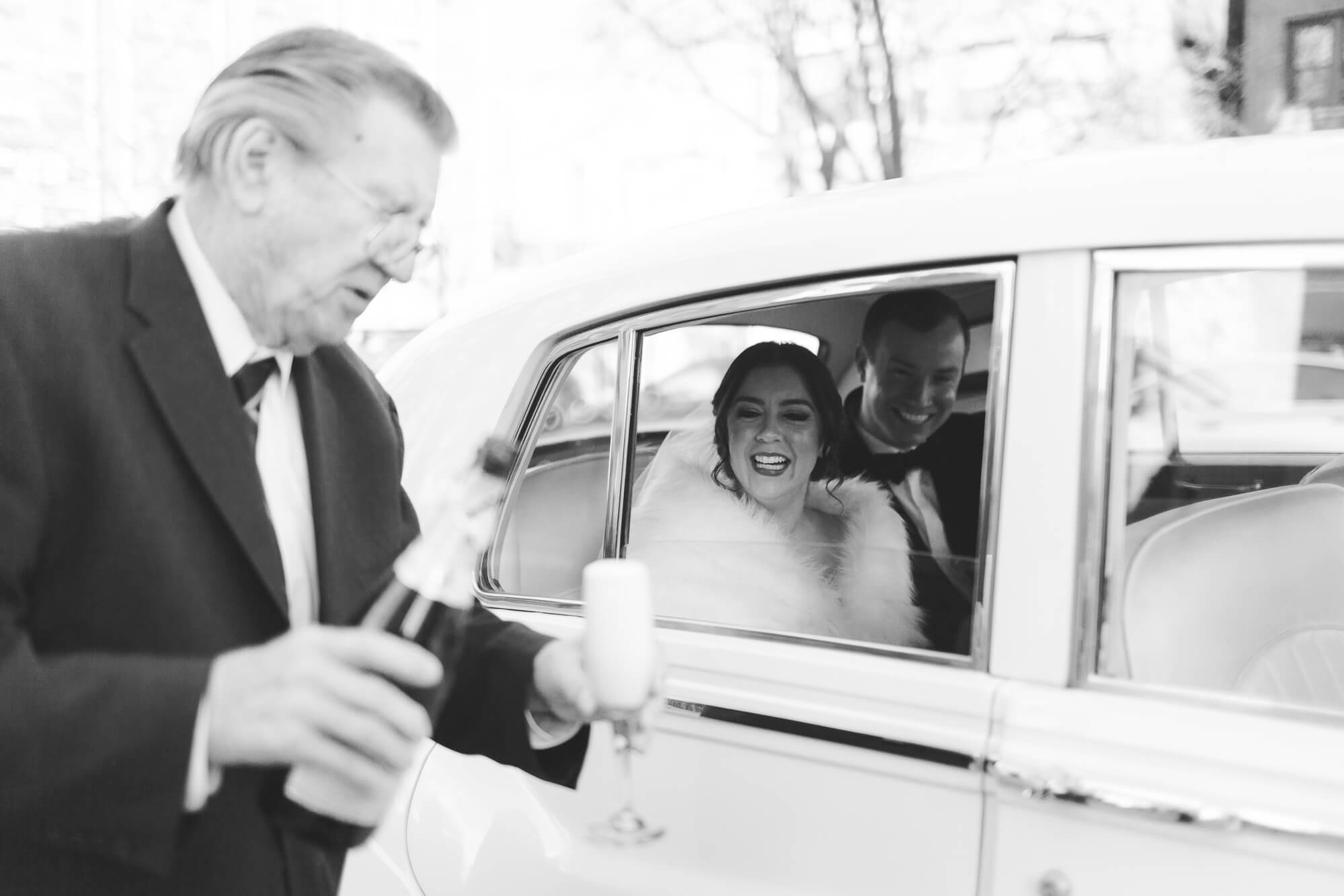 father of the bride popping champagne | elegant black tie wedding oahu hawaii family photography elle rose photo | glamorous destination winter wedding at thompson chicago 