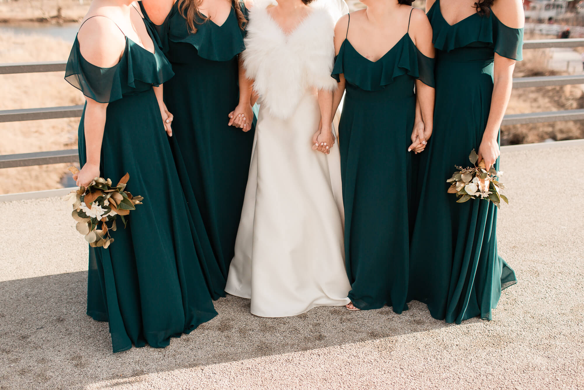 bride holding hands with bridesmaids in dark green dresses | elegant glamorous black tie daytime wedding photography | oahu hawaii wedding photographer elle rose photo | destination winter wedding in chicago illinois