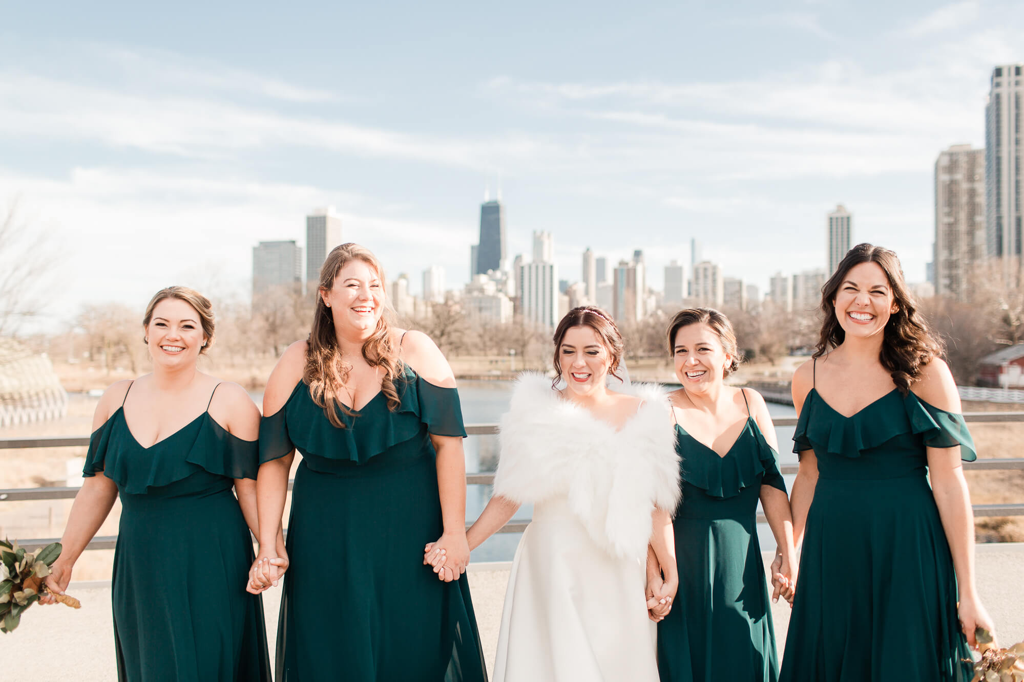 bride and bridesmaids in from of chicago city skyline | elegant black tie wedding oahu hawaii family photography elle rose photo | glamorous destination winter wedding at thompson chicago 