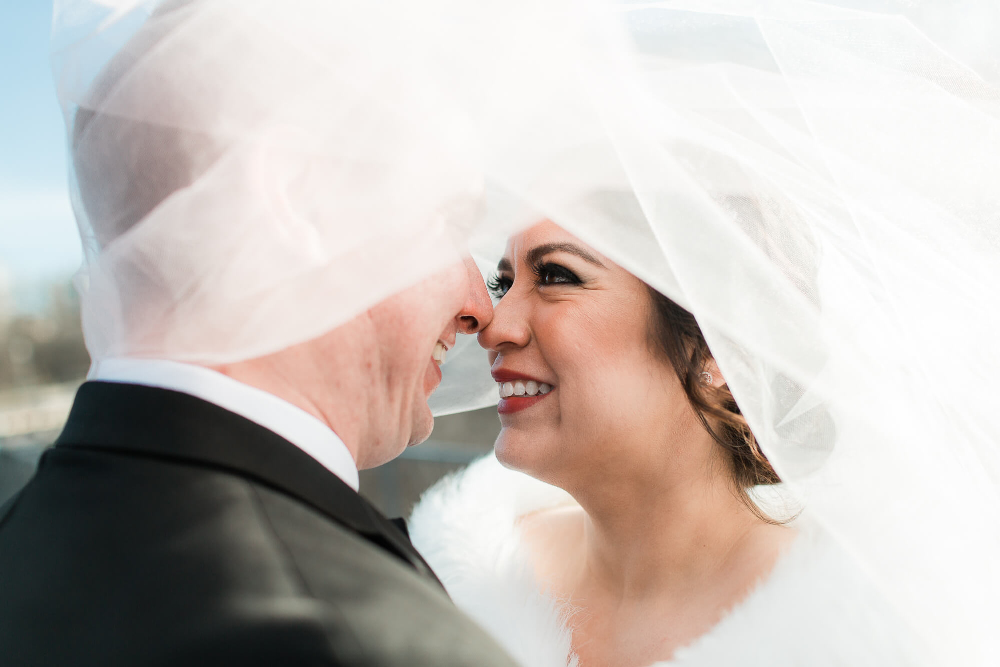 bride touching nose with groom under veil | elegant glamorous black tie daytime wedding photography | oahu hawaii wedding photographer elle rose photo | destination winter wedding in chicago illinois