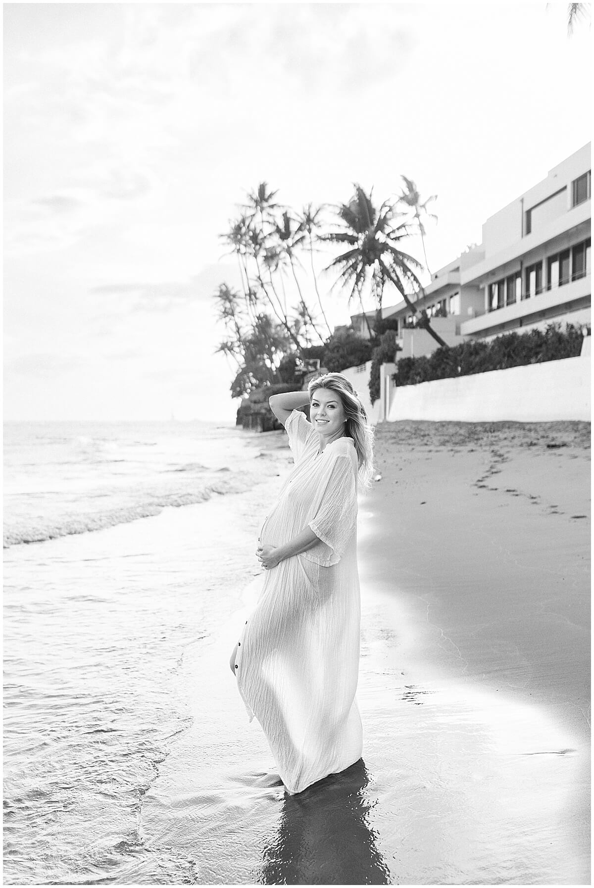 Black and white maternity photography of new mom in white gown for Beach maternity session