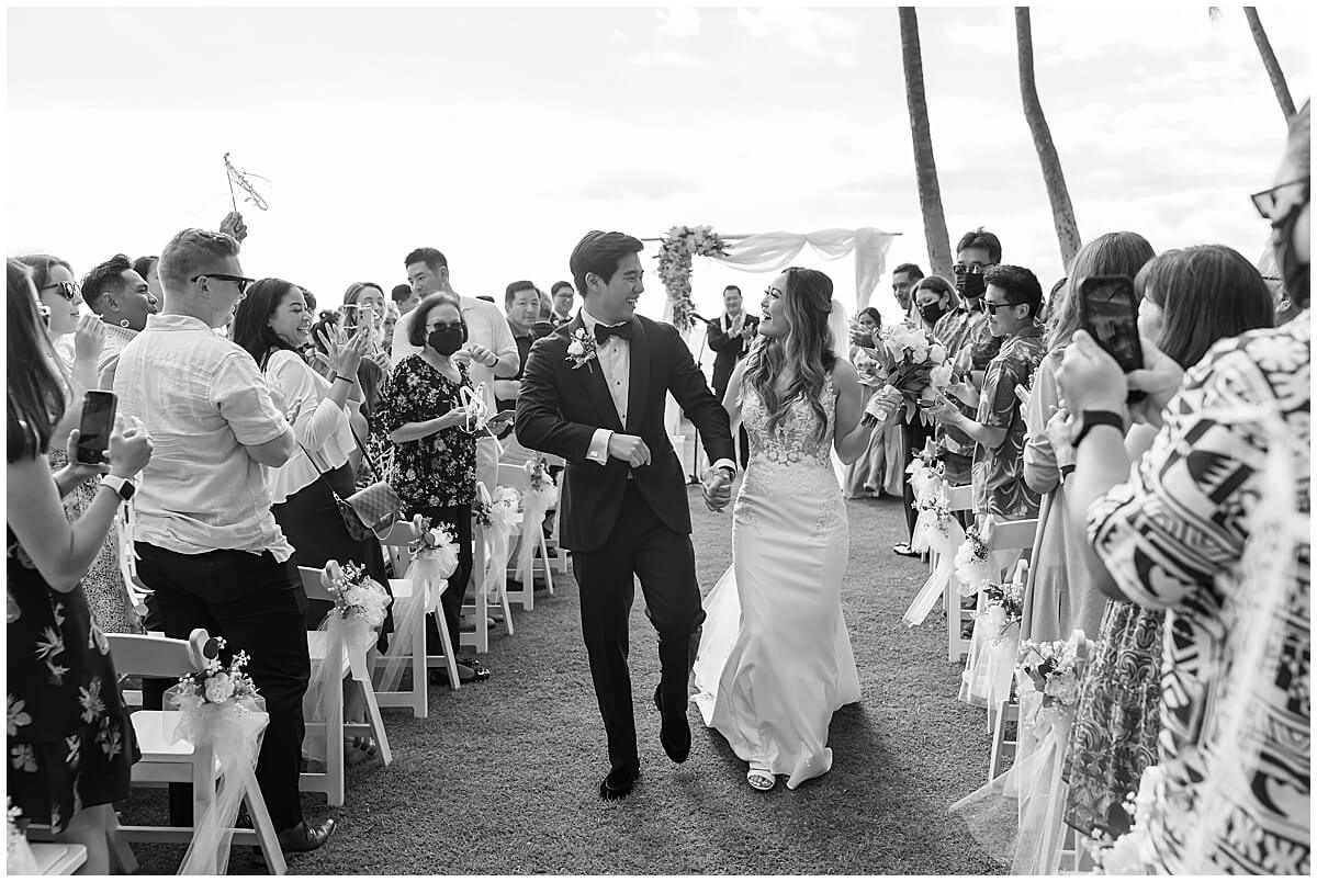 newly married couple walking up the aisle after wedding ceremony by Elle rose photo