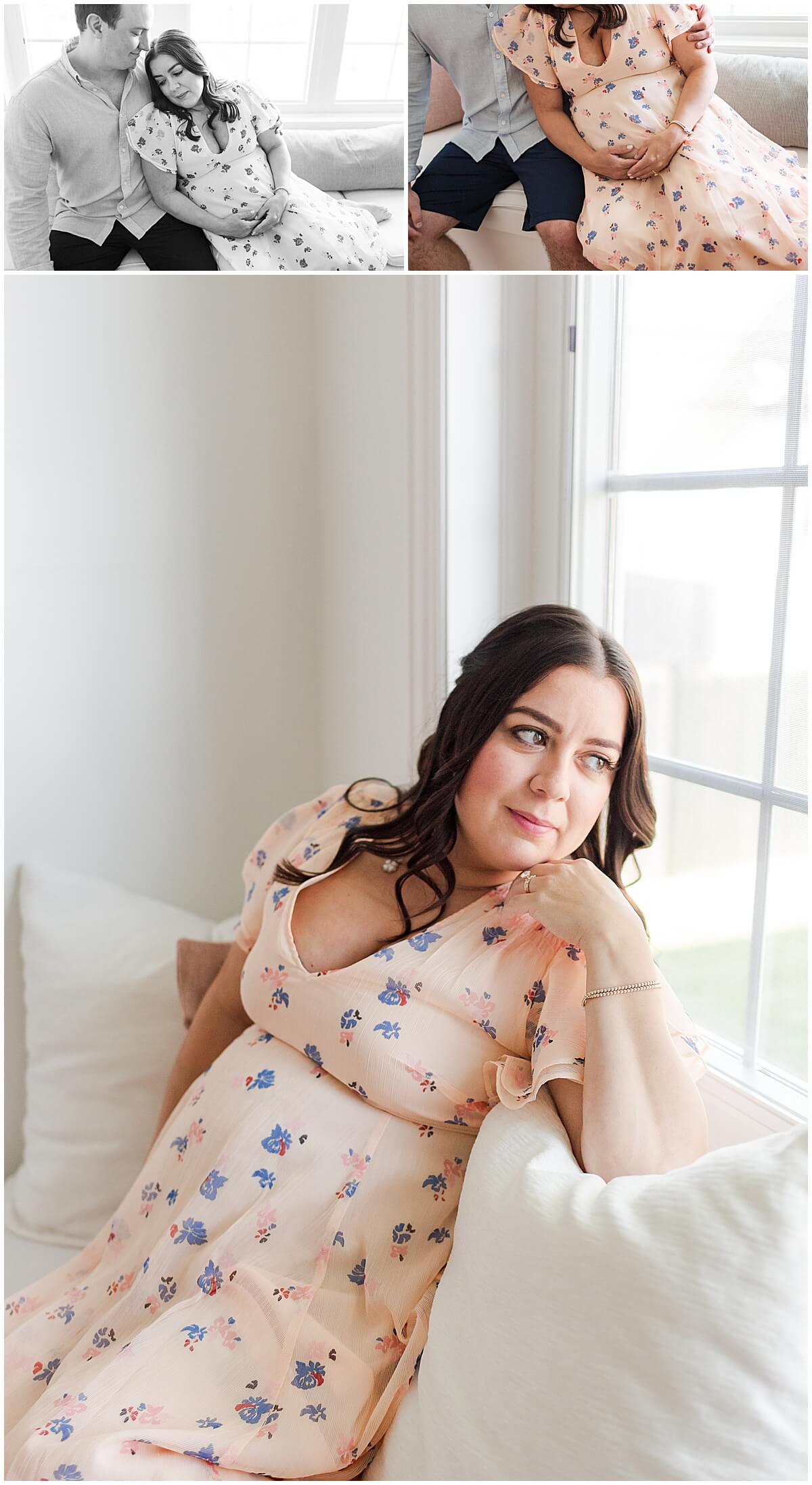new mom wearing floral maternity dress on white daybed for in home maternity session 