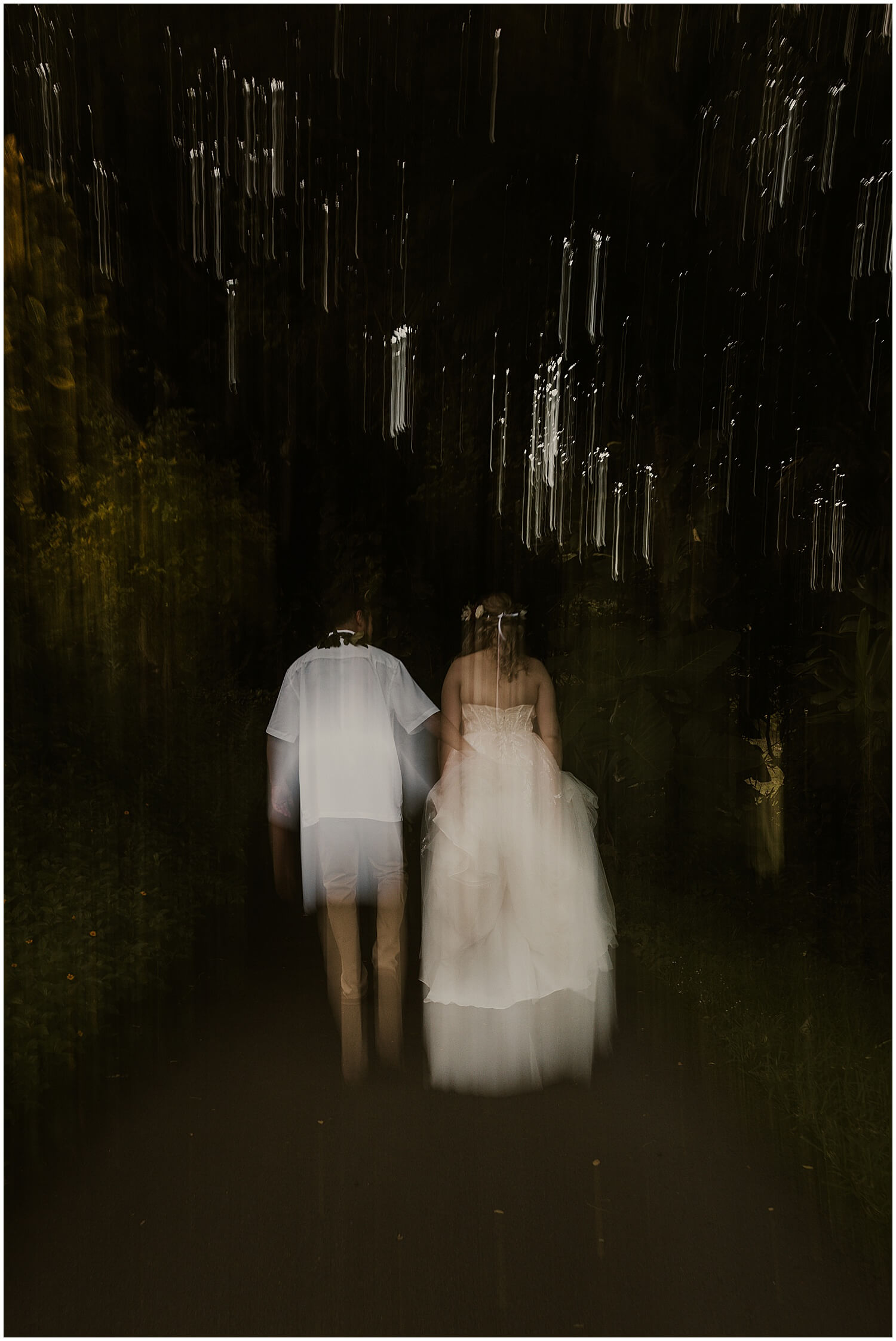 Bride and groom walking along path from ceremony location at Kualoa ranch by Elle rose photo 